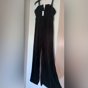 New green velvet jumpsuit with tag .